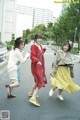 A group of young women walking down a street.