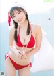 A woman in a red bikini and a santa hat.